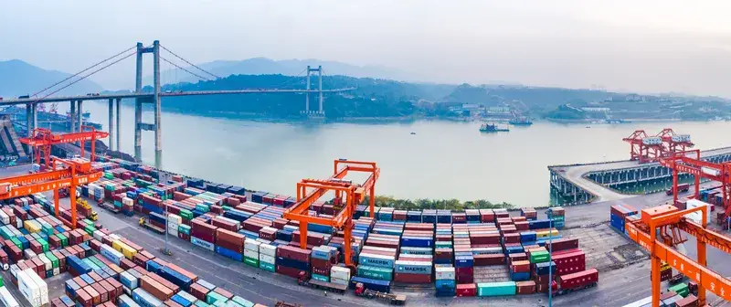 Aerial view of container port with cranes and bridge for global shipping